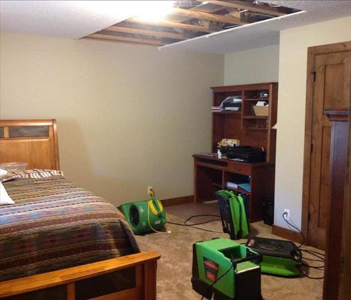 A bedroom with air movers set up